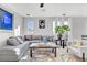 Comfortable gray sectional sofa and stylish decor fills a sunlit living room at 10415 Scarpa St, Las Vegas, NV 89178