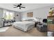 Comfortable bedroom featuring a queen bed, ceiling fan, and a large window with natural light at 10415 Scarpa St, Las Vegas, NV 89178