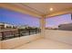 Balcony with modern railing and a neighborhood view during sunset at 12160 Harris Summit Ave, Las Vegas, NV 89138