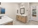 Contemporary bathroom with dual vanities, sleek mirrors, and door to main bedroom at 12160 Harris Summit Ave, Las Vegas, NV 89138