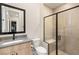 Modern bathroom with a glass enclosed shower and wood grain vanity at 12160 Harris Summit Ave, Las Vegas, NV 89138