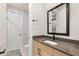 Modern bathroom with a sleek vanity, black hardware, and a framed mirror at 12160 Harris Summit Ave, Las Vegas, NV 89138