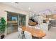 Open concept dining area with a view of the modern kitchen and stairs at 12160 Harris Summit Ave, Las Vegas, NV 89138