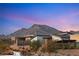 This home with modern architecture has desert landscaping and mountain views at 12160 Harris Summit Ave, Las Vegas, NV 89138