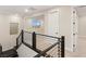 Hallway landing with modern railing and natural light at 12160 Harris Summit Ave, Las Vegas, NV 89138