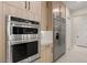 Modern kitchen featuring stainless appliances, an oven and a refrigerator with light wood finish cabinetry at 12160 Harris Summit Ave, Las Vegas, NV 89138