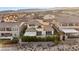 The rear of this home features a balcony, desert landscaping, and a hedge at 12160 Harris Summit Ave, Las Vegas, NV 89138