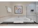 The bathroom is bright with a soaking tub and glass shower, and an elegant framed painting at 125 E Harmon Ave # 809, Las Vegas, NV 89109