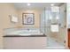 Serene bathroom with a soaking tub, glass shower, and soft lighting at 125 E Harmon Ave # 809, Las Vegas, NV 89109