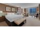 Bedroom with city view, king bed, seating area, and stylish decor at 125 E Harmon Ave # 809, Las Vegas, NV 89109