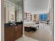 Bedroom with large windows offering city views, along with a bar and seating area at 125 E Harmon Ave # 809, Las Vegas, NV 89109