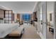 Bedroom featuring a comfortable bed, city views, and a functional kitchenette at 125 E Harmon Ave # 809, Las Vegas, NV 89109