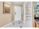 Hallway features a doorway view to the bathroom with a tub and white tile at 125 E Harmon Ave # 809, Las Vegas, NV 89109