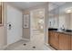 Hallway view with a bathroom featuring a soaking tub through an open doorway at 125 E Harmon Ave # 809, Las Vegas, NV 89109