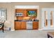 Kitchenette featuring wood cabinets, sink, microwave, refrigerator, and wall-mounted television at 125 E Harmon Ave # 809, Las Vegas, NV 89109