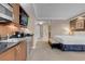 A kitchenette with stainless steel appliances is adjacent to a serene bedroom area at 125 E Harmon Ave # 809, Las Vegas, NV 89109