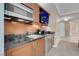 A kitchenette with stainless steel appliances and a modern countertop adjoins a bedroom at 125 E Harmon Ave # 809, Las Vegas, NV 89109