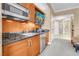 Kitchenette featuring wood cabinets, sink, microwave, refrigerator, and marble countertops at 125 E Harmon Ave # 809, Las Vegas, NV 89109