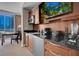 Elegant kitchenette featuring wood cabinetry, granite countertops, and stainless steel appliances at 125 E Harmon Ave # 809, Las Vegas, NV 89109