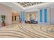 Grand lobby boasts decorative tile flooring, stone accent wall with art and modern lighting fixtures at 125 E Harmon Ave # 809, Las Vegas, NV 89109