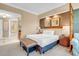 Bedroom featuring a king bed, bedside tables, and seating area with access to a bathroom at 125 E Harmon Ave # 809, Las Vegas, NV 89109