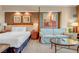 Bedroom showcasing a king bed, sitting area, and decorative wall art at 125 E Harmon Ave # 809, Las Vegas, NV 89109