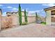 Well-manicured backyard with brickwork, tall hedges, landscaping, and water feature at 12816 Alcores St, Las Vegas, NV 89141