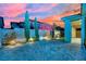 The backyard features a modern waterfall feature with beautiful landscaping and colorful sunset views at 12816 Alcores St, Las Vegas, NV 89141