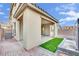 Exterior view of the covered patio and backyard with a modern water feature at 12816 Alcores St, Las Vegas, NV 89141