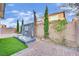 Beautiful backyard features a decorative water fountain, landscaping, and brickwork at 12816 Alcores St, Las Vegas, NV 89141