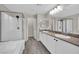 An elegant bathroom featuring double sinks, a soaking tub, and a glass-enclosed shower at 12816 Alcores St, Las Vegas, NV 89141