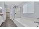 Bathroom with a glass-enclosed shower, large soaking tub, and linen closet, designed for relaxation at 12816 Alcores St, Las Vegas, NV 89141