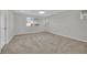 Bedroom featuring light grey walls, gray carpet, and large window for natural lighting at 12816 Alcores St, Las Vegas, NV 89141