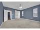 Inviting bedroom with neutral carpet, ensuite bathroom access via sliding barn door, and ample natural light at 12816 Alcores St, Las Vegas, NV 89141