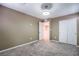 Bedroom featuring neutral carpet and base trim, closet with mirrored doors, and neutral walls at 12816 Alcores St, Las Vegas, NV 89141