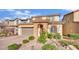 Picturesque exterior showcasing a brick driveway, desert landscaping, and an arched entryway at 12816 Alcores St, Las Vegas, NV 89141