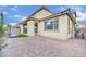 Home exterior view highlighting the covered patio and landscaped backyard with water feature at 12816 Alcores St, Las Vegas, NV 89141