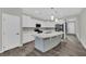 Modern kitchen featuring a large island, quartz countertops, and stainless steel appliances at 12816 Alcores St, Las Vegas, NV 89141