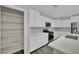 A bright kitchen features white cabinets, stainless steel appliances, and a walk-in pantry at 12816 Alcores St, Las Vegas, NV 89141