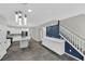 A modern kitchen features white cabinetry, stainless steel appliances, and stairs to the second floor at 12816 Alcores St, Las Vegas, NV 89141