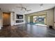 Spacious living room with fireplace, built-in shelving, and sliding glass doors to the outdoor patio at 12816 Alcores St, Las Vegas, NV 89141