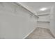 Bright walk-in closet with white walls, gray carpet, and shelving and railing system at 12816 Alcores St, Las Vegas, NV 89141