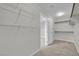 Walk-in closet with gray carpet, shelving, and a doorway leading to other rooms in the home at 12816 Alcores St, Las Vegas, NV 89141