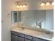 Bright bathroom featuring a double sink vanity with granite countertop and a large mirror at 1331 Ebbetts Pass, Las Vegas, NV 89110