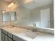 Bright bathroom featuring a double sink vanity with granite countertop and a large mirror at 1331 Ebbetts Pass, Las Vegas, NV 89110