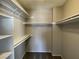 Walk-in closet features built-in shelving units and carpeting at 1331 Ebbetts Pass, Las Vegas, NV 89110