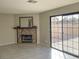 Cozy living room with a stone fireplace and sliding glass door to backyard at 1331 Ebbetts Pass, Las Vegas, NV 89110