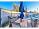 Outdoor dining area with shaded seating, stone table, pool views and privacy fence at 1805 Ivanhoe Way, Las Vegas, NV 89102