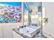 Unfinished bathroom boasts a sink, decorative wall art, and a mirror that amplifies the light and space at 1805 Ivanhoe Way, Las Vegas, NV 89102