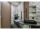 Secondary bathroom featuring modern sink, stone accent wall and modern lighting at 1805 Ivanhoe Way, Las Vegas, NV 89102